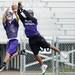 Pioneer High School football players reach for the ball during a drill on the first day of practice on Monday, August 12, 2013. Melanie Maxwell | AnnArbor.com